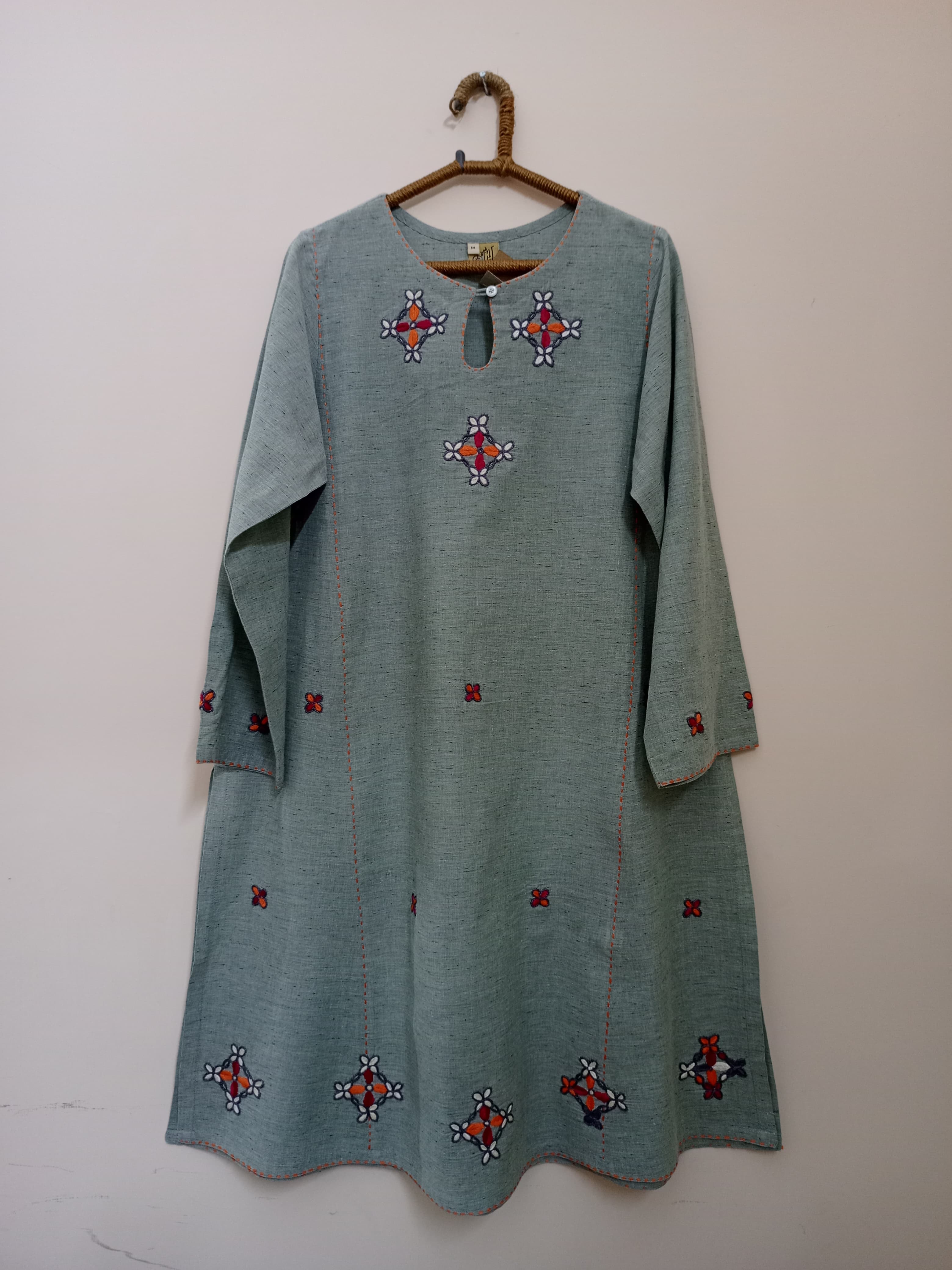 This light green embroidered shirt features delicate patterns, soft pastel tone, airy texture, and polished detailing for effortless comfort and understated luxury.